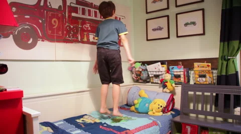 Happy kid having fun, jumps on bed, child enjoying, naughty boy, bedroom Stock Footage 43115886