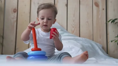 Happy kid is playing. Child development is a montessori game. Kid plays with Stock Footage 154999660