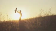 Happy Kid Playing With Toy Airplane Against Orange Sun Summer Sky Background Stock Footage