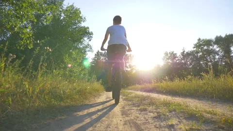 Happy kid riding a bike in a park at Stock Video Pond5