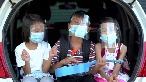 Happy kid on trunk car sing a song, family kids wearing mask and face shield Stock Footage 132586824