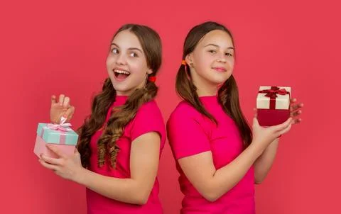 Happy kids with present boxes on red background Stock Photos