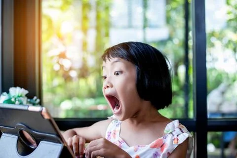 Happy kids using a laptop computer at home Stock Photos