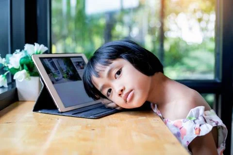 Happy kids using a laptop computer at home Stock Photos