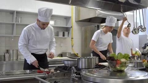 Happy kitchen crew with chef singing and dancing while cooking Stock Footage 102748640