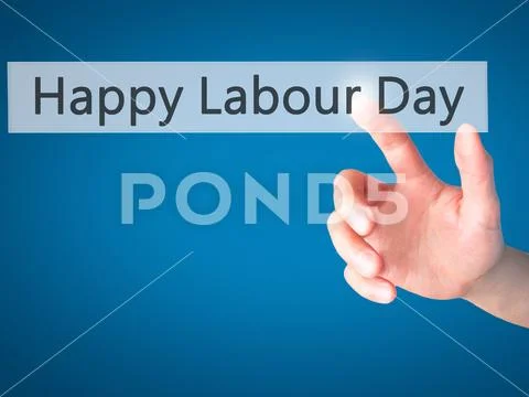 Happy Labour Day - Hand pressing a button on blurred background Stock Photos