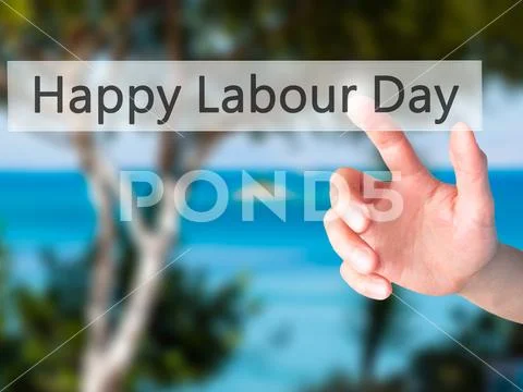 Happy Labour Day - Hand pressing a button on blurred background Stock Photos