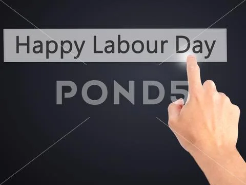 Happy Labour Day - Hand pressing a button on blurred background Stock Photos
