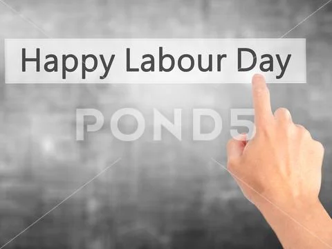 Happy Labour Day - Hand pressing a button on blurred background Stock Photos