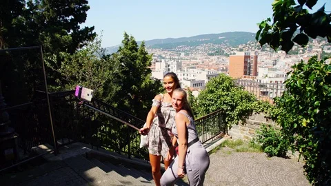 Happy ladies make selfie using monopod against landscape Stock Footage 116722677