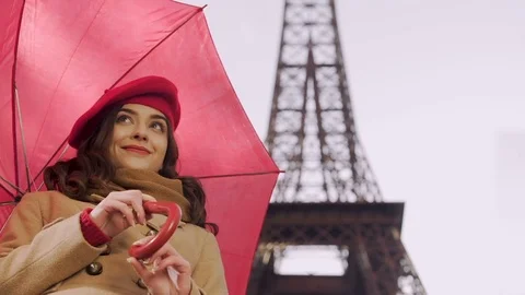 Happy lady standing under umbrella smiling to passers-by waiting for her friend Stock Footage 83904468
