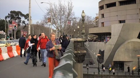 A happy lady using tablet computer taking photos on Princess Bridge 動画素材 93686443
