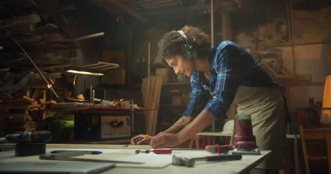 Happy Latin carpentry worker planning handicraft project from wood at workshop Stock Footage 140557504