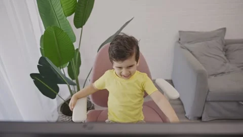Happy laughing toddler having fun watching cartoons on computer Stock Footage 246129166
