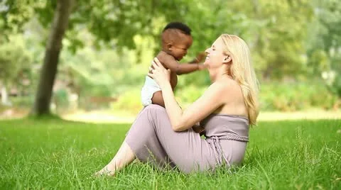 Happy little African American baby smiling while playing with his mother. Stock Footage
