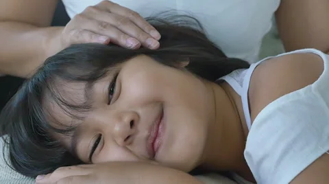 480px x 268px - Happy little Asian girl sleep on her mother's lap