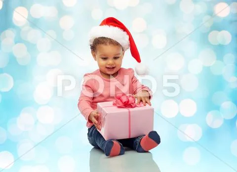 Happy little baby girl with christmas present Stock Photos
