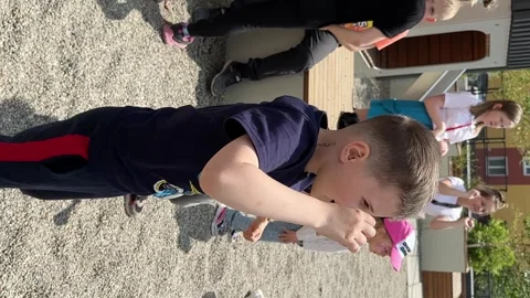 Happy little boy having fun and dancing on the playground in the courtyard of Stock Footage 246474390