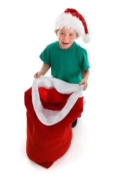 Happy little boy holding open santa sack Stock Photos