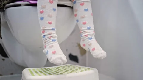 Close Up of Female Legs of a Woman in a Toilet Room Taking Off Her