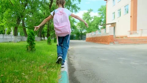 Happy little girl back to school. Child goes to school with backpack. Girl with  Stock Footage 279874341