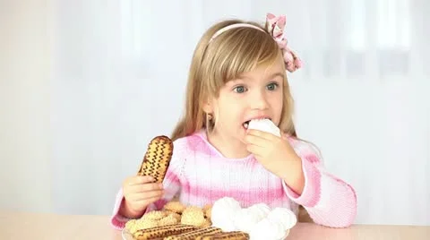 Happy little girl eats candy Stock Footage