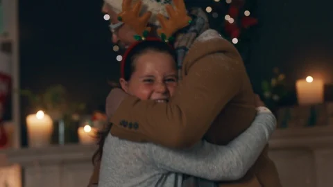 Happy little girl hugging grandmother visiting for christmas family gathering Stock Footage