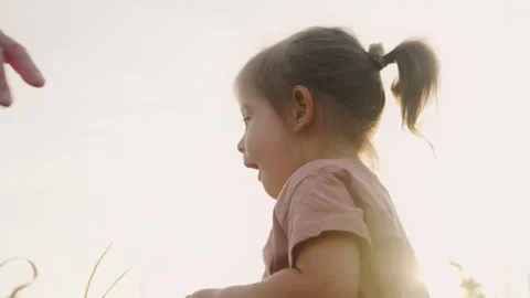 Happy little girl standing with her mother through cornfield. Positive emotions Stock Footage 247257553