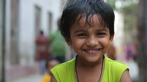 Happy little Indian boy on a city street. Stock Footage
