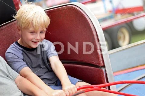 Happy Little Kid Riding Tilt-a-whirl Carnvial Ride Stock Photos