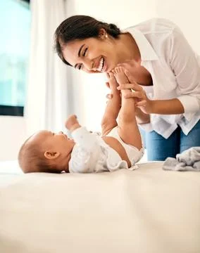 Happy, love and a mama with her baby in the bedroom of their home together for Stock Photos