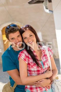 Happy love couple embracing smiling in city Stock Photos