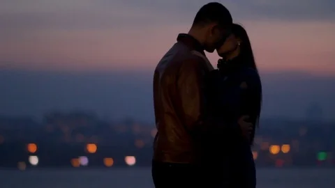 Happy lovers cuddle against the background of a night city Video stock 80021399