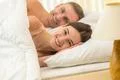 The happy lovers pair lay on the bed Photo