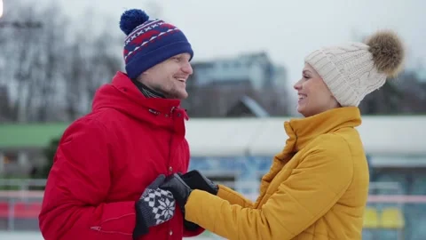 Happy lovers skating and talking at outdoor ice rink Stock Footage 142396401