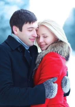 Happy lovers young couple hugging in winter day Stock Photos