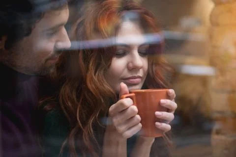 Happy loving couple drinking hot beverage indoors Stock Photos