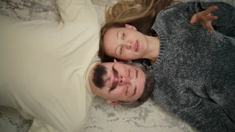 Happy loving couple lying down together on floor Stock Footage 340931145