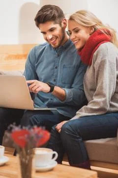 Happy loving couple using notebook at home Stock Photos