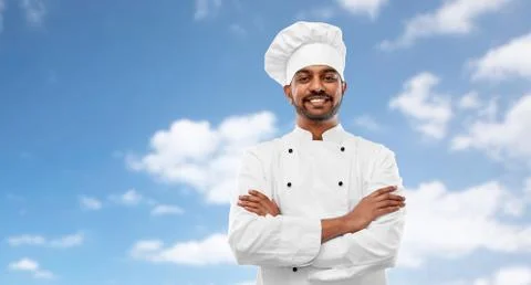 Happy male indian chef in toque Stock Photos