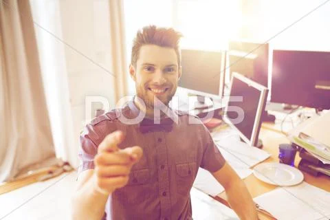 Happy male office worker pointing finger at you Stock Photos