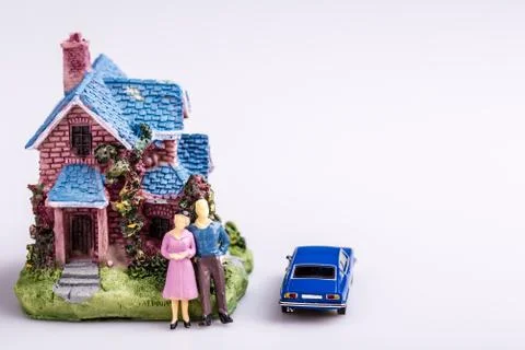 Happy man and wife with blue car and new house, real estate, mortgage Stock Photos