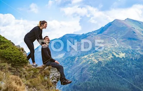 The happy man and a woman enjoying on the beautiful cliff Stock Photos
