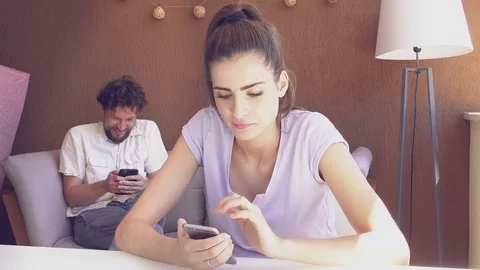 Happy man and woman having fun texting on social network Stock Footage