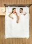 The happy man and woman lay on the bed. View from above Photo