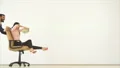 The happy man and a woman playing with a chair and a money. slow motion 4k or 4k+ Resolution