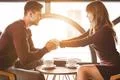 The happy man and a woman sit at the restaurant table Photo