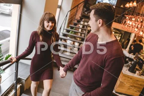The happy man and a woman stand in the restaurant Stock Photos