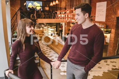 The happy man and a woman stand in the restaurant Stock Photos