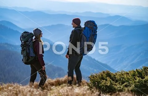 The happy man and a woman standing on the cliff with a beautiful view Stock Photos